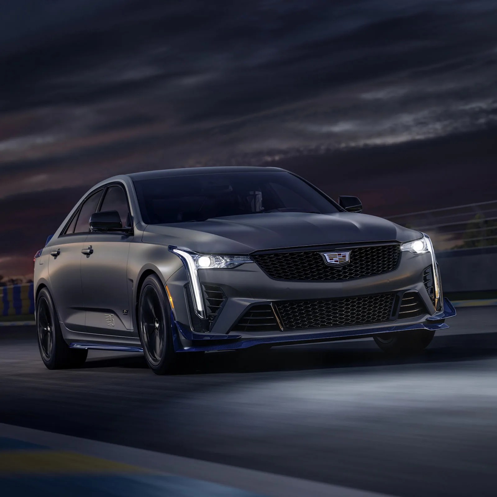 Cadillac 2025 CT4-V BLACKWING PETIT PATAUD EDITION shown driving on track at night with headlamps on.