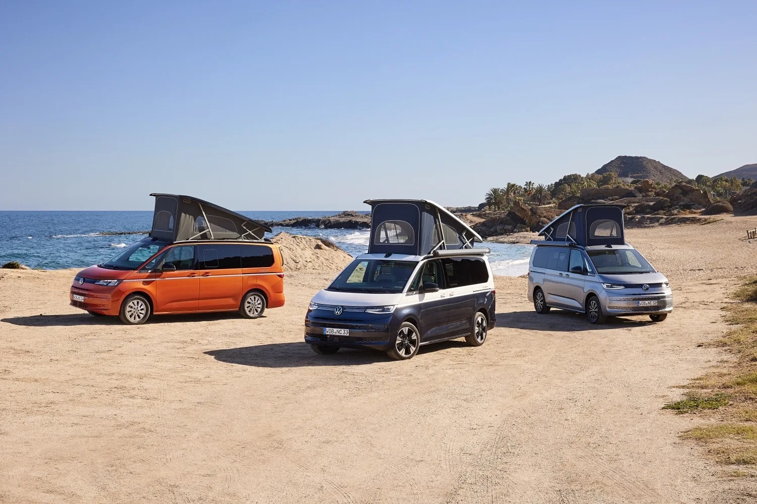 three vw camper vans on a beach