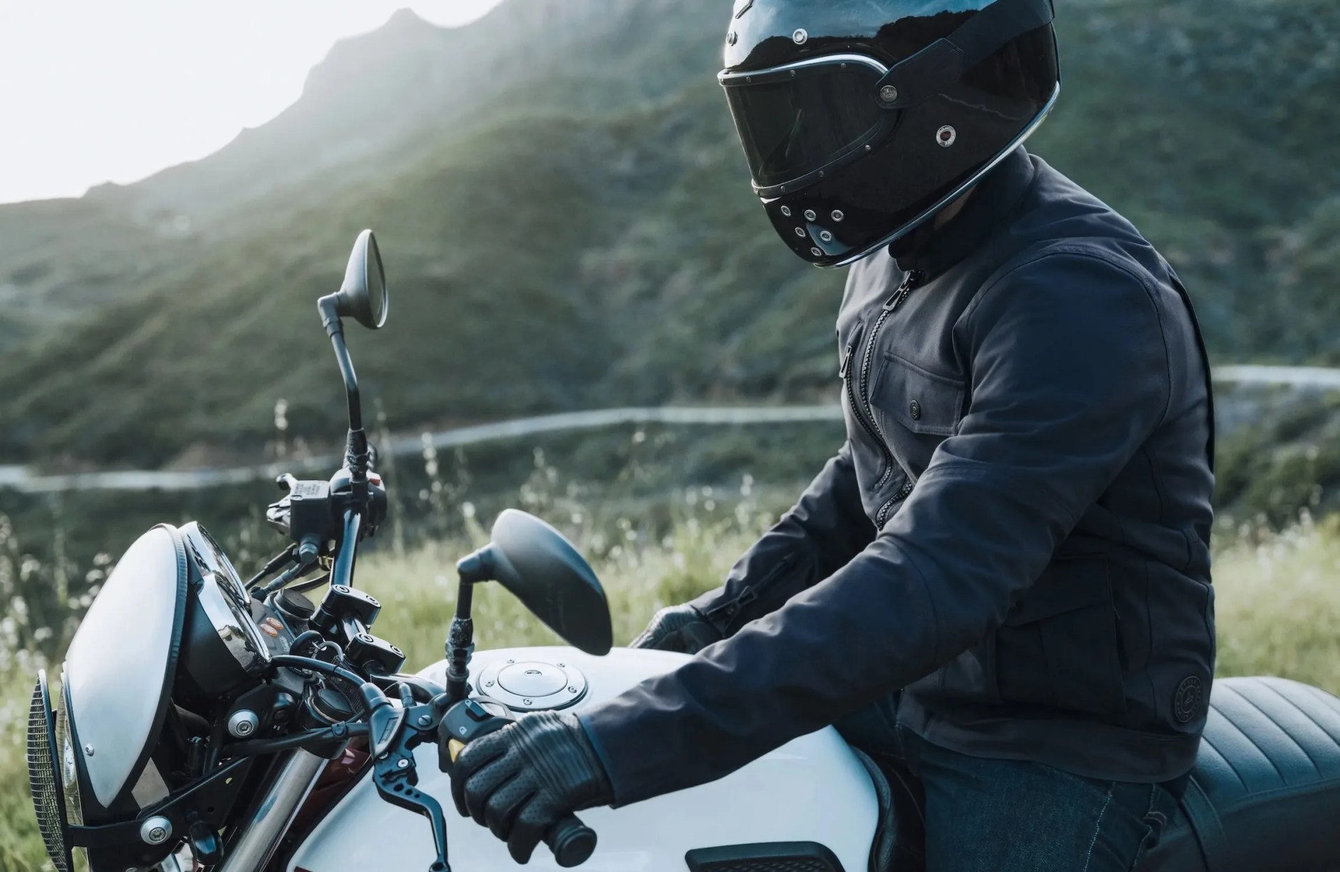 rider wearing aether mulholland moto jacket on moto guzzi motorcycle