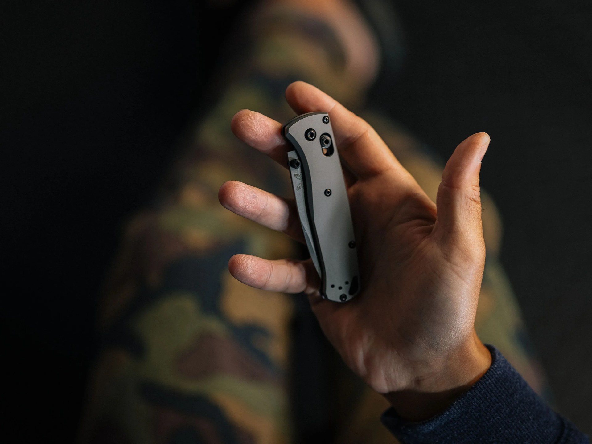 a hand holding a folding pocket knife