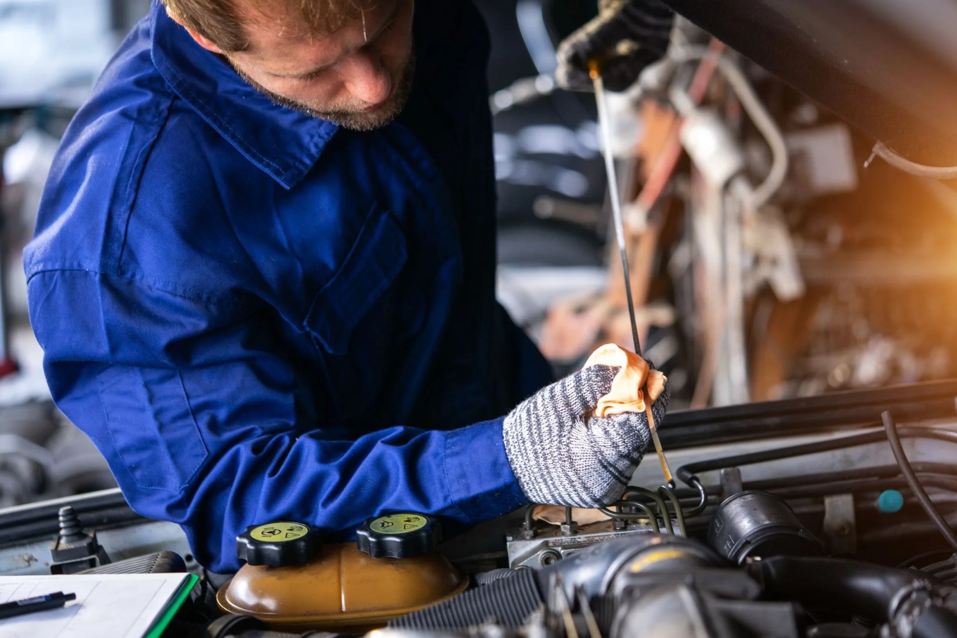 car repair concept,engineer checking oil level in car service centre