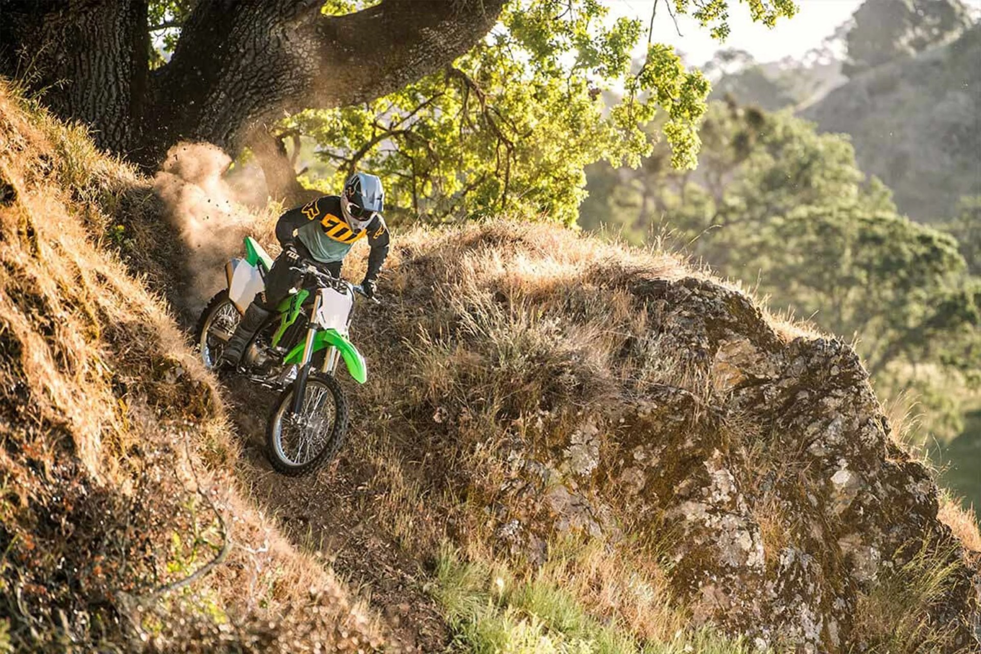 person riding a motorcycle down a dirt hill