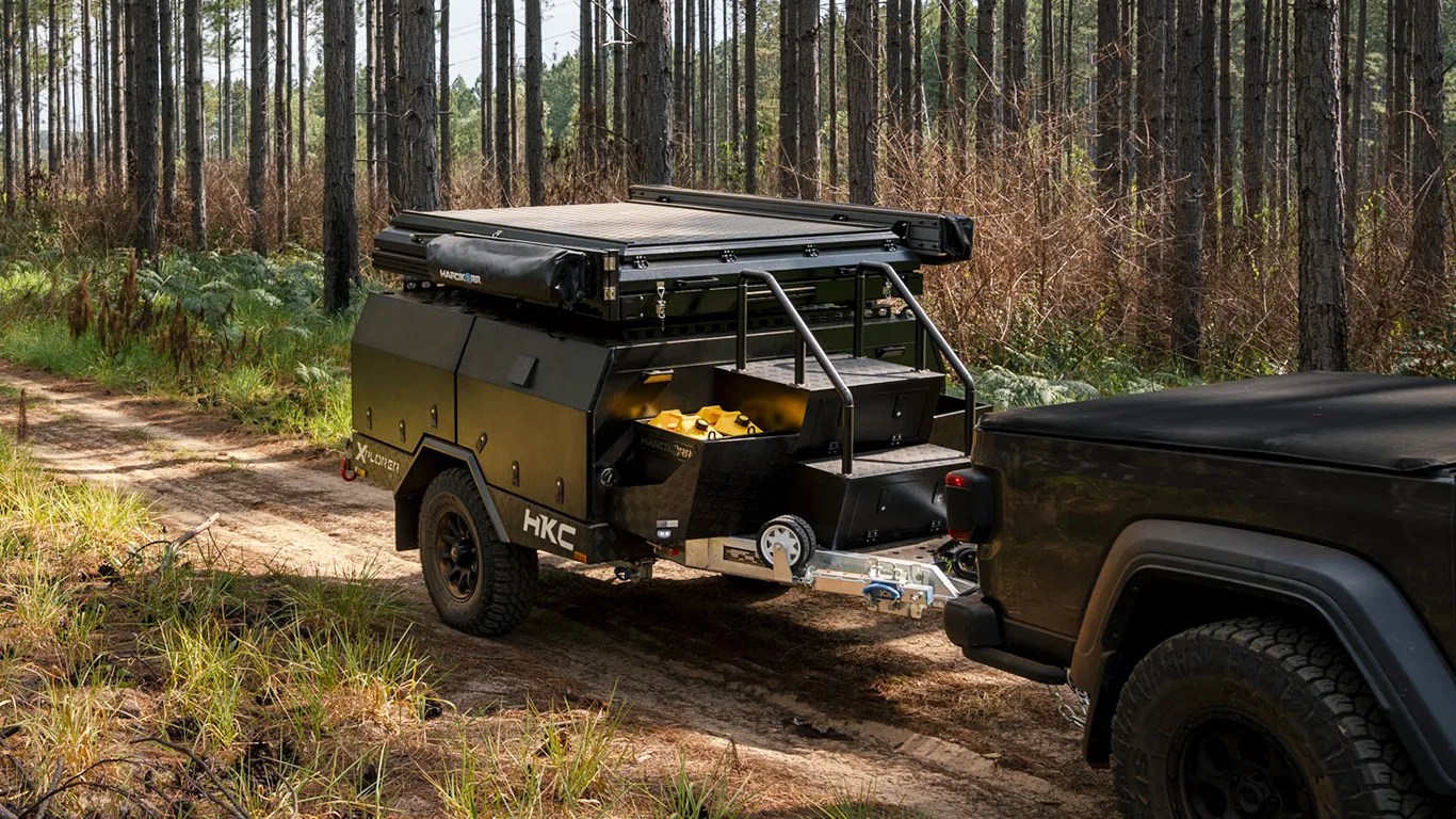 hardkore campers trailer being towed through the woods