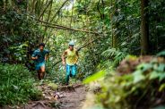 pair of runners running through the wilderness in bright apparel