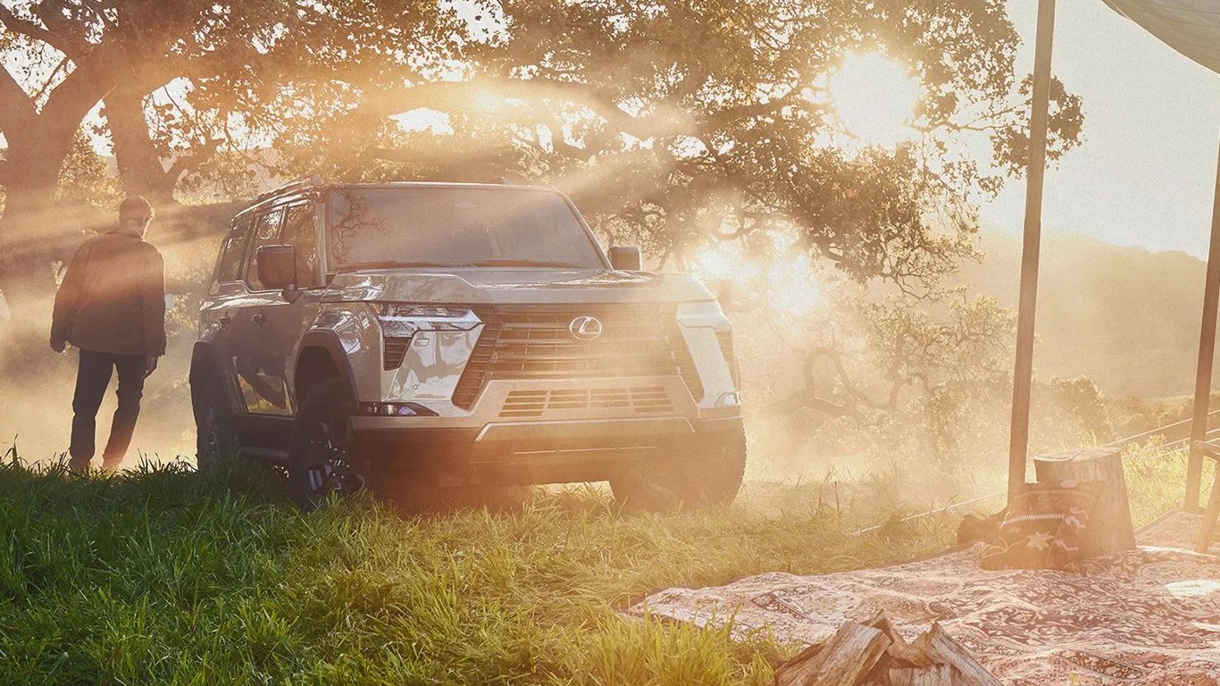 a lexus suv at a campsite with a man walking behind it