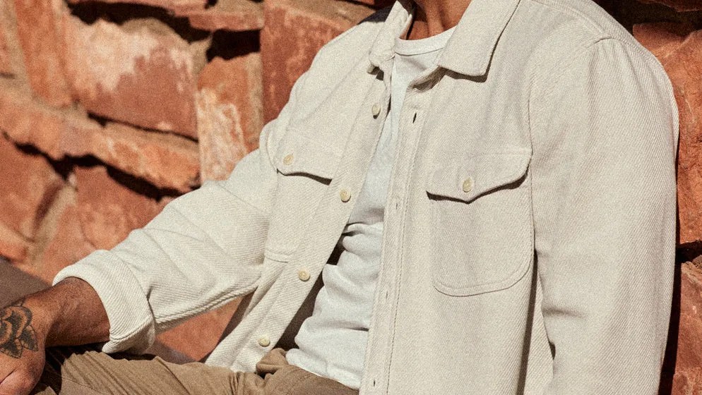 Outerknown Chroma Blanket shirt in white being worn in red desert setting.