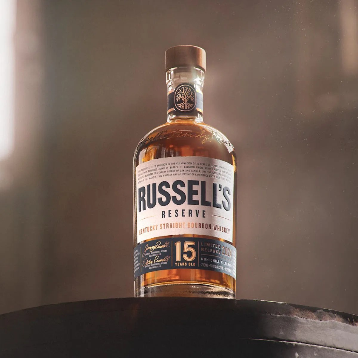 A bottle of Russell’s Reserve 15 Year Limited release bourbon sitting on a bourbon barrel in a bourbon aging warehouse