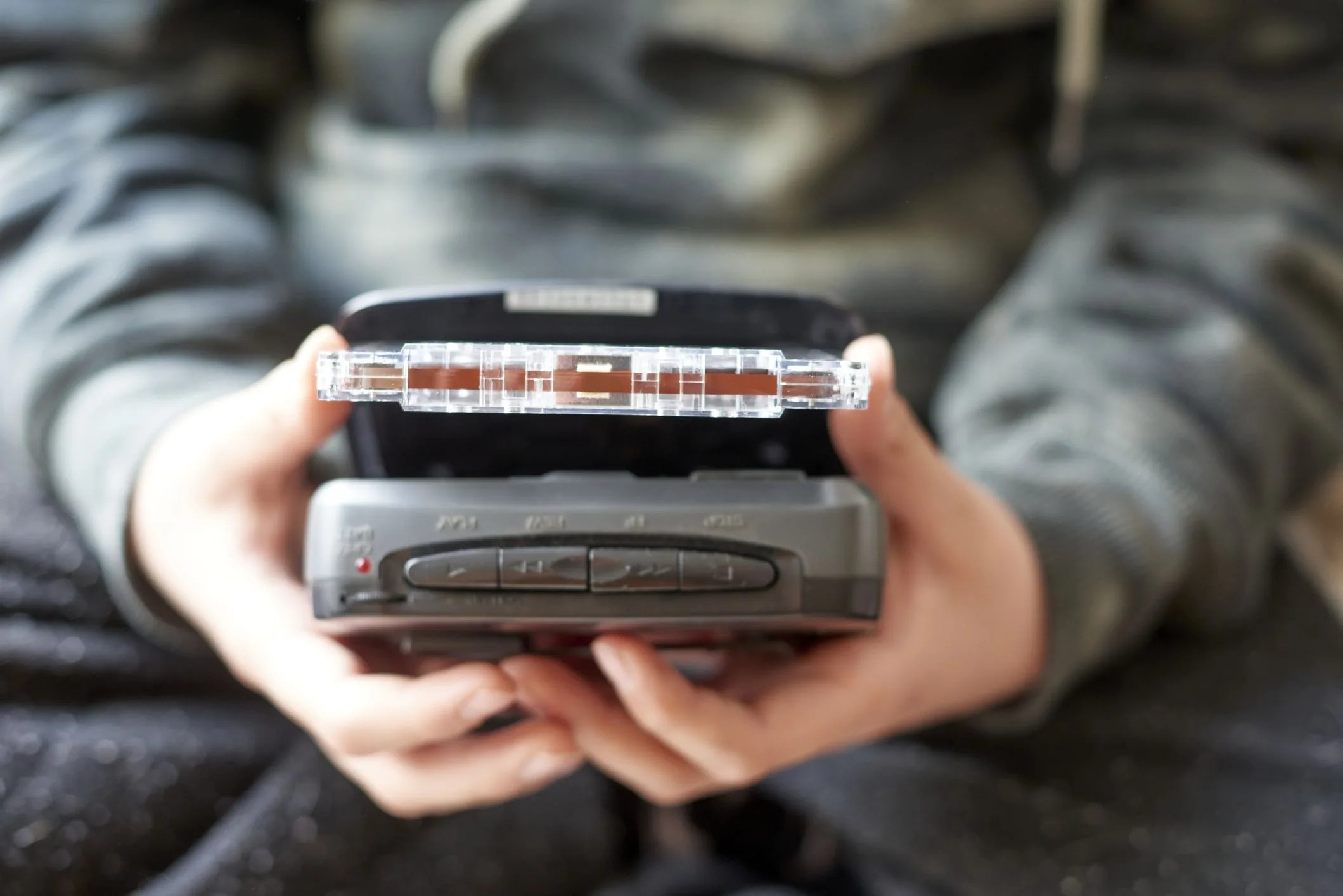 boy holding an audio cassette