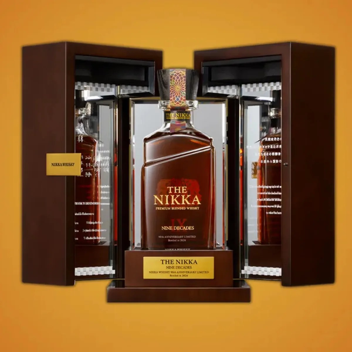 A bottle of The Nikka Nine Decades global whisky presented in its wooden box on an orange colored background