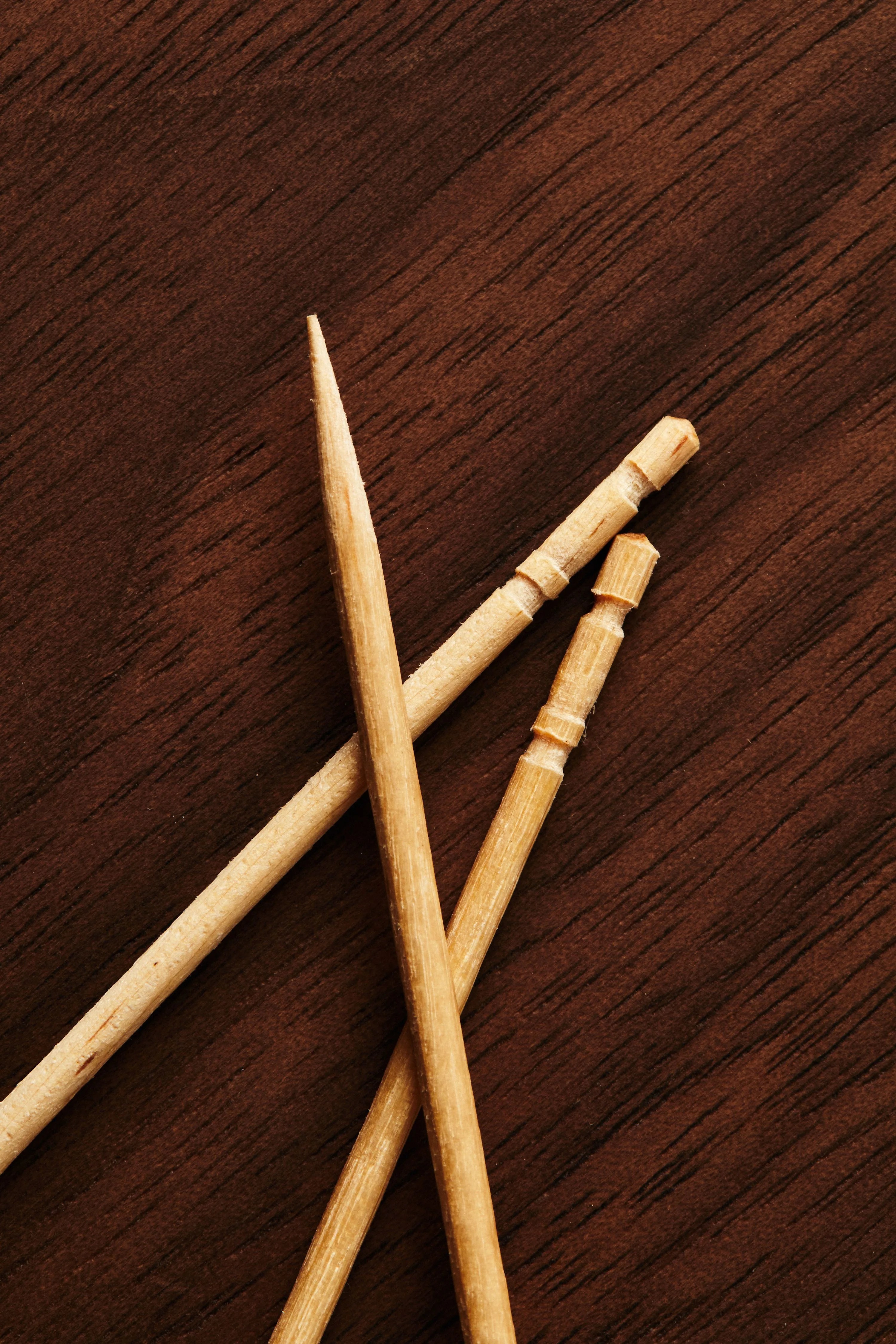 three toothpicks on wooden table