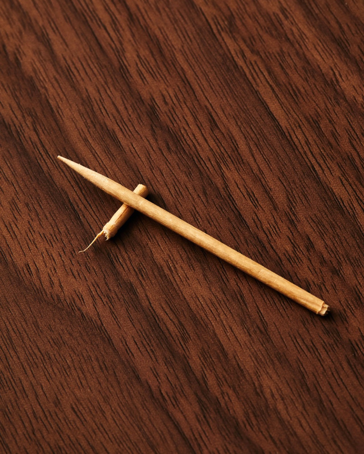 broken toothpick on wooden table