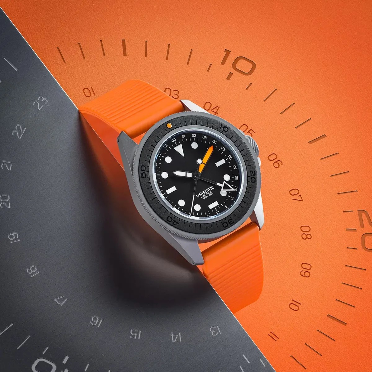 Unimatric Modello Uno u1S T GMT ET watch shown on black and orange background.