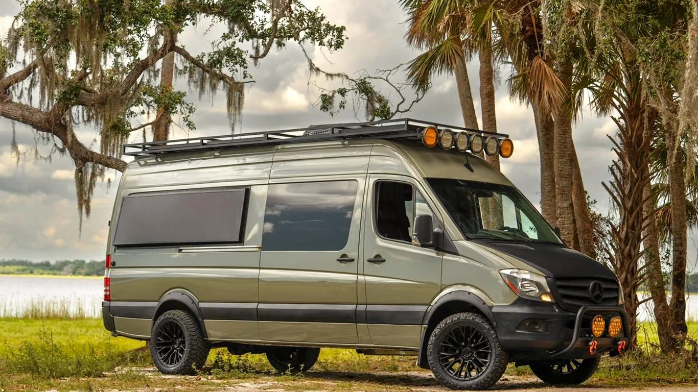 war horse all terrain camper van next to palm trees