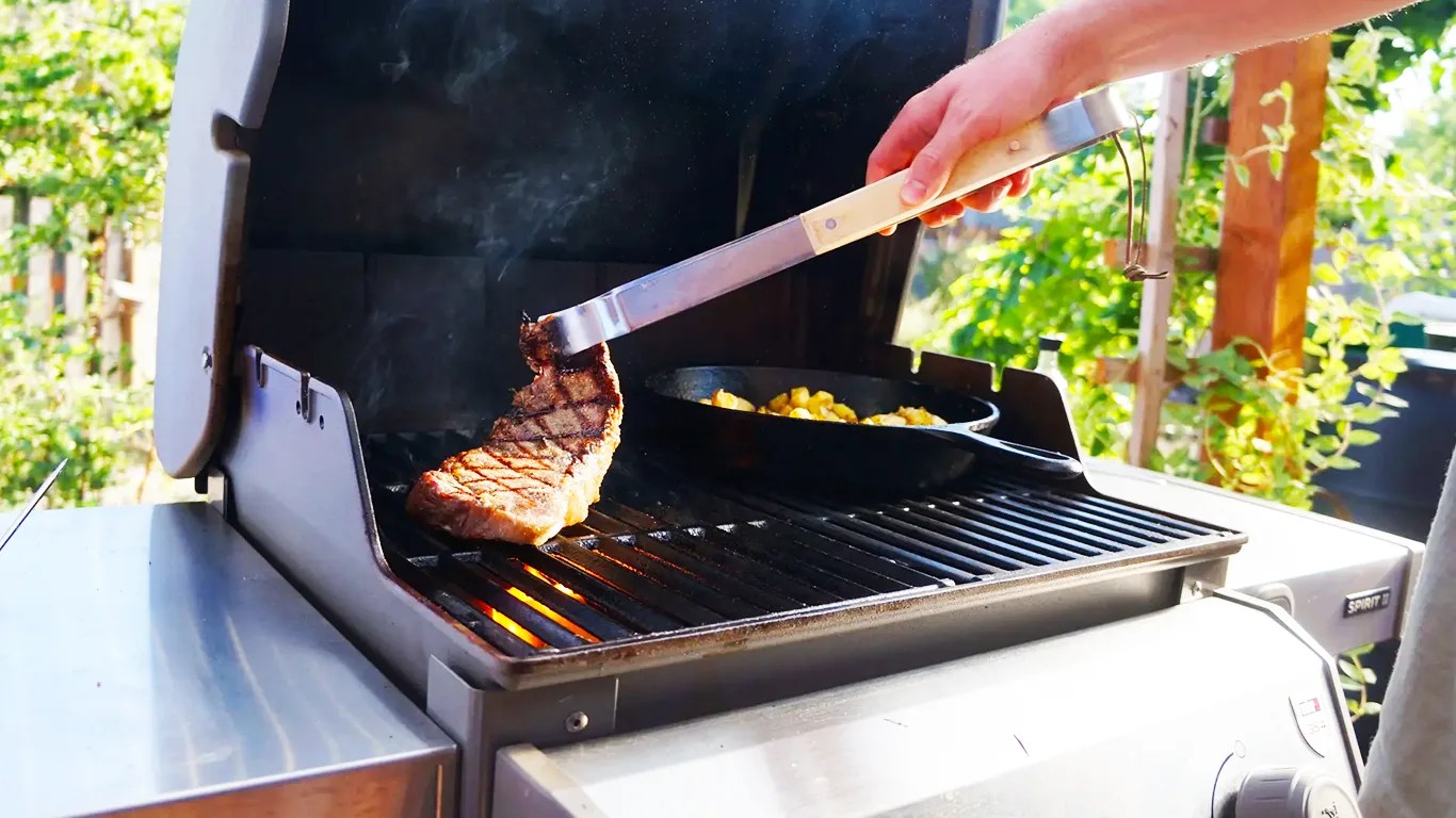 a person grilling a steak